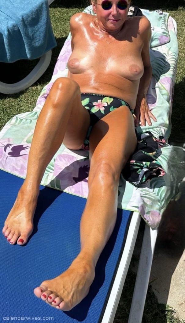 Loving wive sunbathing topless.